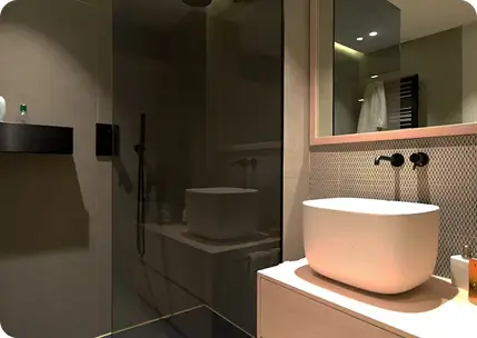 Modern bathroom vanity with vessel sink and custom plumbing