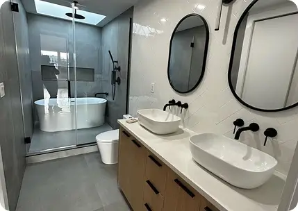 Luxury bathroom renovation with double vanity and walk-in shower