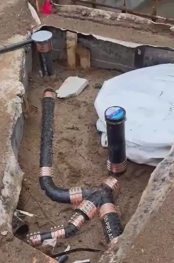 New sewer and plumbing pipe installation before concrete pour