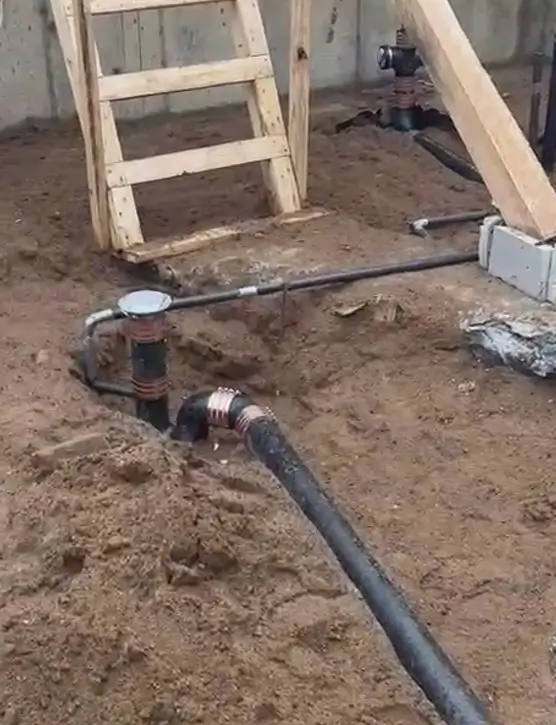 Drain pipe installation under house foundation