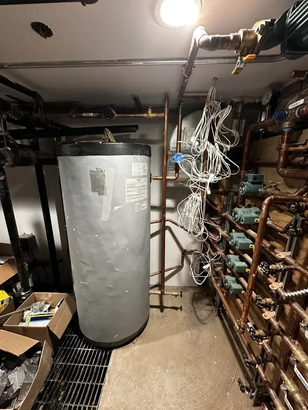 Water heater and plumbing manifold