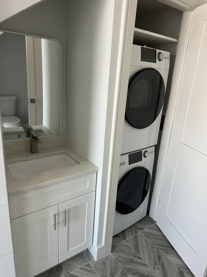 Laundry room vanity and stacked washer and dryer