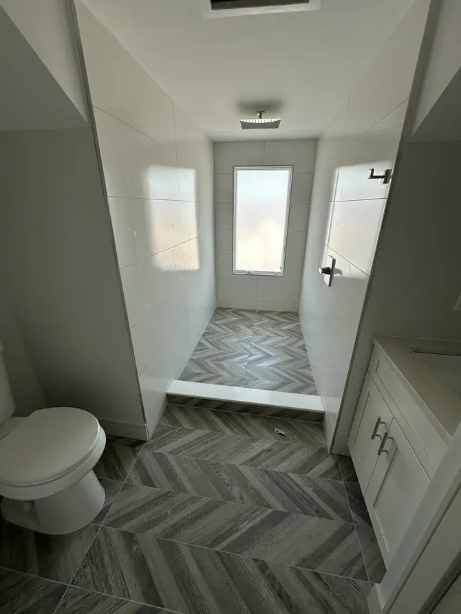 Residential hallway with herringbone tile flooring