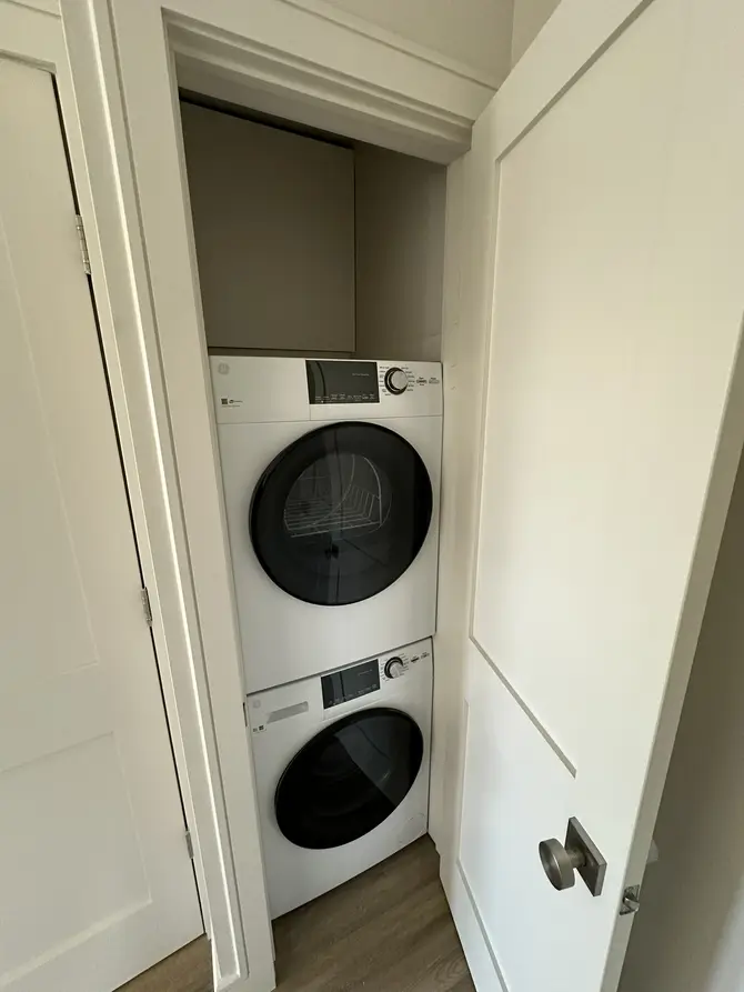 Laundry closet with stacked washer and dryer